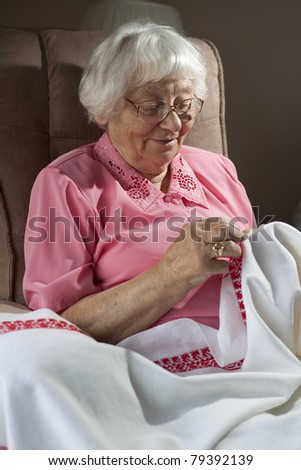 Active senior woman embroidering