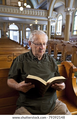 Senior man reading a bible in church