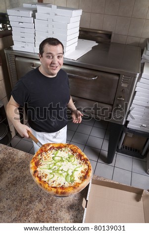Chef with fresh take out pizza