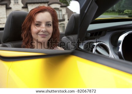 Reflection of a young woman in a sports car