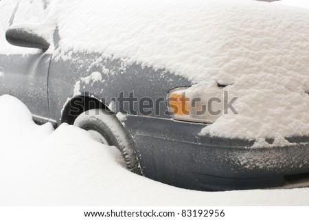 Car buried in deep snow after a blizzard