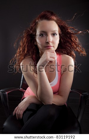 Young woman studio portrait (redhead sitting)