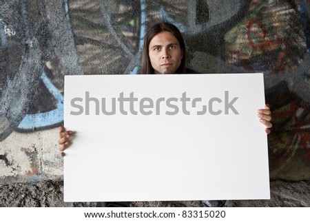 Homeless man with blank sign