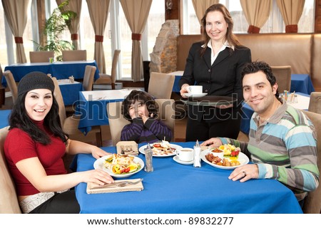 Happy family having breakfast at a restaurant