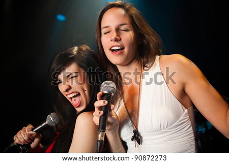 Female singers performing, soft and hard duet