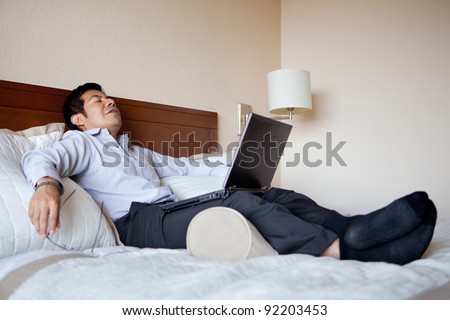 Hispanic businessman resting in his hotel room