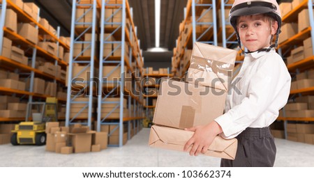 Child wearing a motorbike helmet carrying parcels in a transportation warehouse