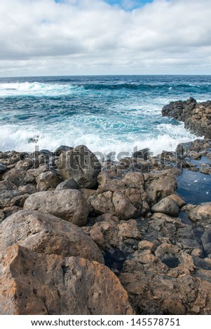 The ocean and breakwater made of lava rocks