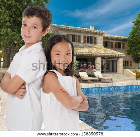 Happy kids by a beautiful house with swimming pool