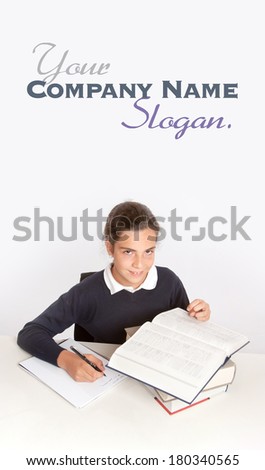 Schoolgirl consulting a dictionary while writing an essay