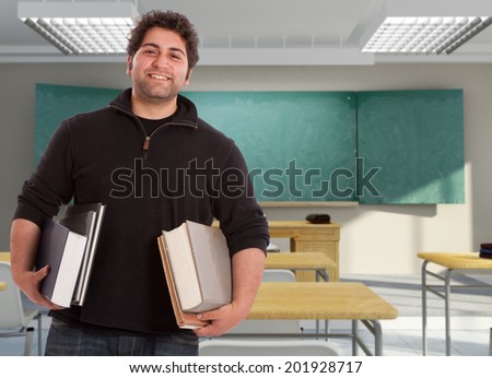Smiling young man holding books in a maths classroom