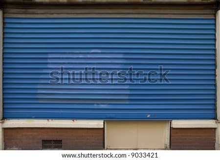 Closed store with blue metal shutters