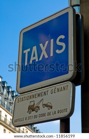 Pole with a taxi sign and a no parking warning sign