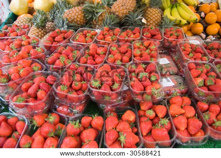Market fruit stall with lots of strawberries