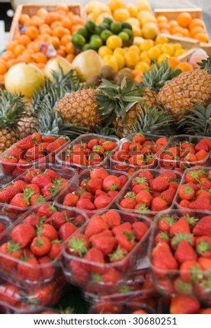 Market fruit stall with lots of strawberries and other fruits