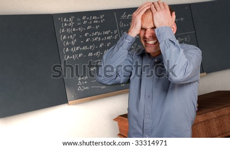 Desperate man in a class with complicated formulae in the blackboard