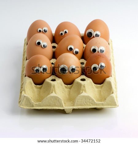 stock photo : A group of eggs in a box with funny eyes