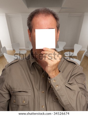 Man with a blank paper hiding his face