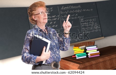 stock photo Friendly mature teacher giving an explanation in a classroom