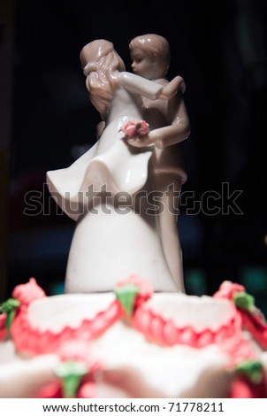 Shot of a wedding cake with a porcelain figurine of the bride and groom