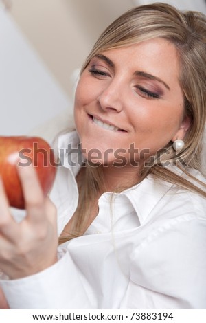 A woman looking longingly to an apple