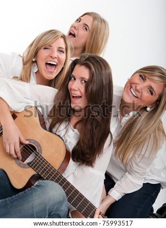 A group of girls singing accompanied by a guitar