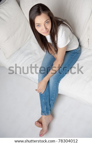 Aerial view of a girl sitting on a sofa