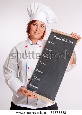 Portrait of a professional female chef holding a menu slate