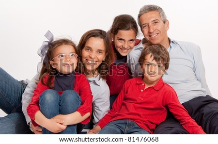 Happy Family portrait with all its members sitting on the floor
