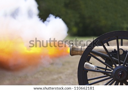 Civil War cannon firing at a civil war re-enactment.
