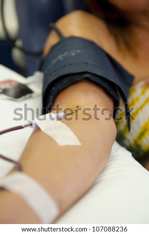 Woman donating blood, plasma, supporting the emergency supplies in hospitals.