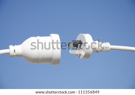 Electricity cable about to connect, isolated with blue sky as background and copy space.