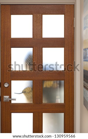 Burglar, thief  with gloves, holding crowbar trying to break in home, unlock door, blurred visible silhouette behind milky windows, with copy space.