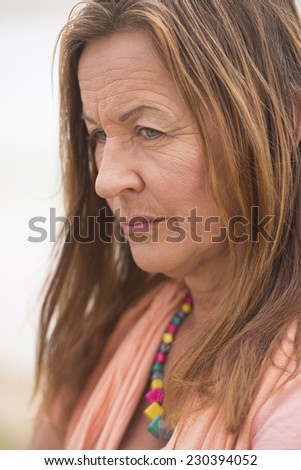 Portrait attractive senior woman with angry, stressed, sad, worried or depressed facial expression, bright outdoor background and copy space.