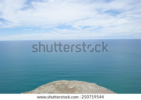 Panoramic lookout over ocean at Bass Strait, Tasmania, Australia, at edge of rocky platform, view to horizon and copy space.