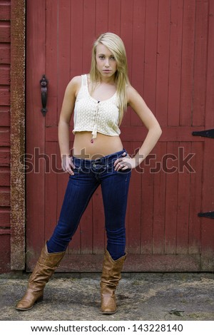 Pretty teen girl in boots and low rise jeans