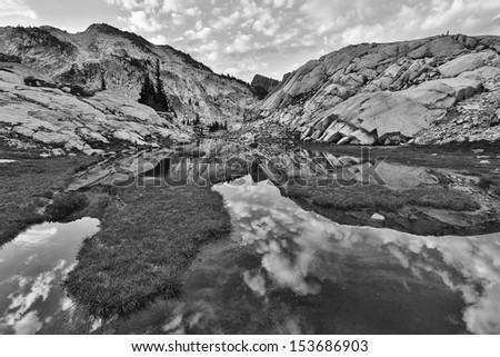Black and white photo of a mountain reflecting in the water