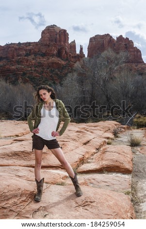 Young brunette model posing outdoors in a desert environment