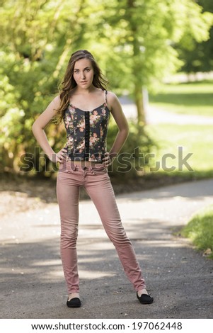 Full body female model in pink jeans and blouse