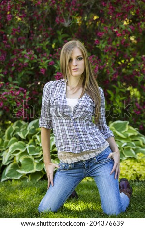 young and sassy brunette girl wearing flannel shirt and jeans