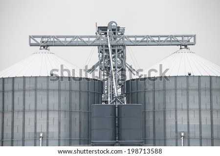 Exterior of storage grain silos covered by snow in winter