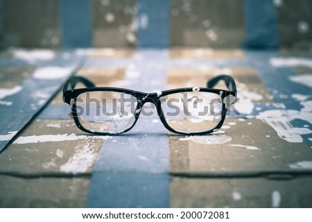 Creative vision conceptual photo, stained eyeglasses on paint background.