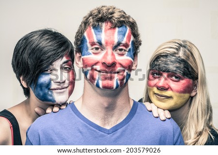 Portrait of young smiling people with painted European flags on their faces.