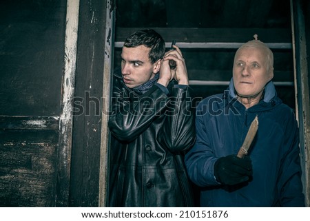 Two dangerous armed men hiding in old dark cabin.