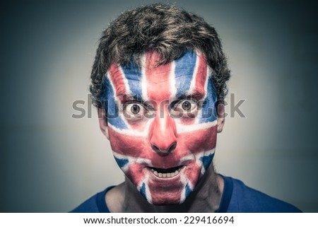 Scary man with British flag painted on face.