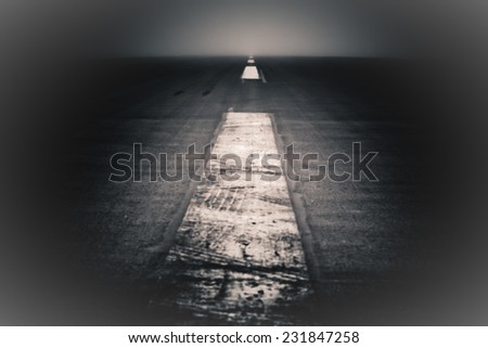 Journey to nowhere. Abstract creative photo of a dramatic dark road and sky.