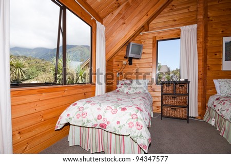 Nice warm interior of mountain wooden lodge bedroom. Fox Glacier Lodge, Fox Glacier, West Coast, South Island, New Zealand.