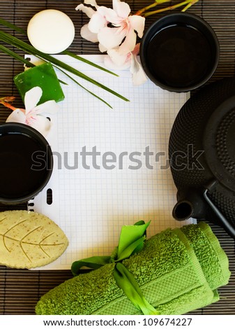 asian tea and spa settings with blank note book on bamboo mat
