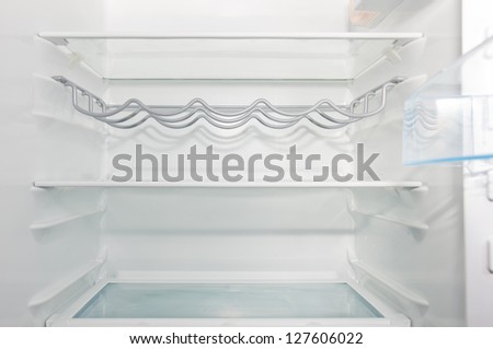empty white  open fridge with some shelves
