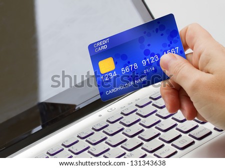 hand holding plastic card  on open notebook background